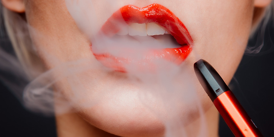 woman with red lipstick vaping