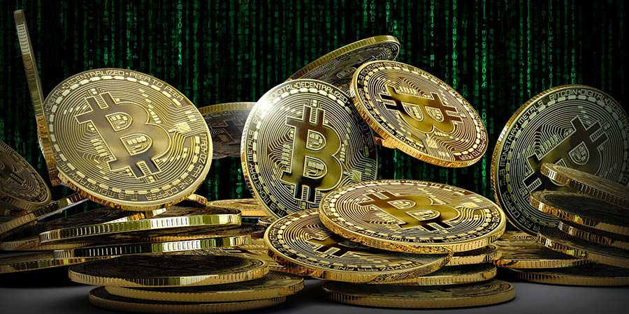 several gold bitcoins and a green matrix background